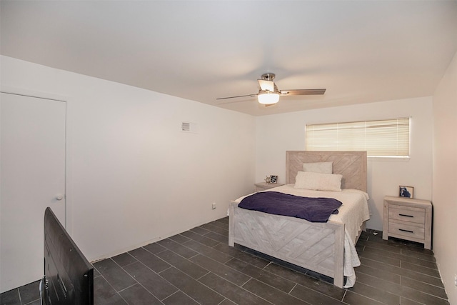bedroom featuring a ceiling fan and visible vents