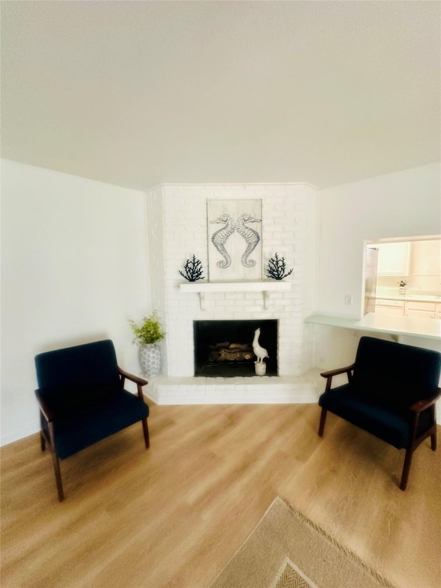 sitting room with wood finished floors and a fireplace