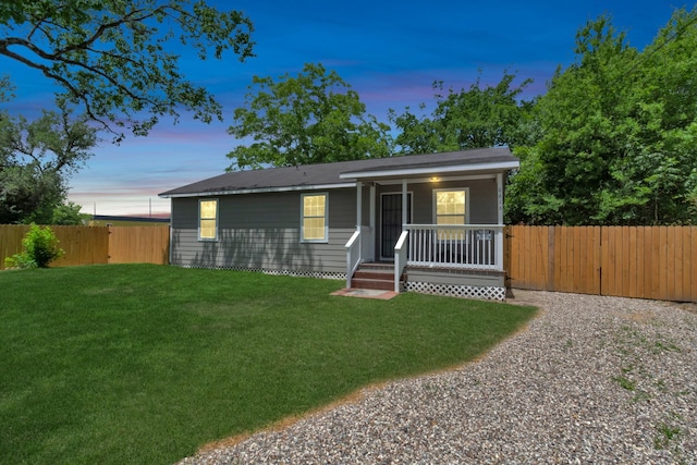 bungalow featuring covered porch, a fenced backyard, and a front yard