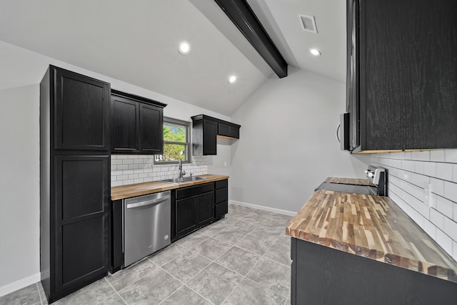 kitchen with dark cabinets, backsplash, butcher block counters, appliances with stainless steel finishes, and a sink