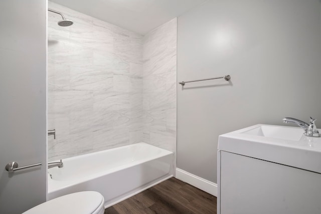 full bath with baseboards, shower / washtub combination, toilet, wood finished floors, and vanity