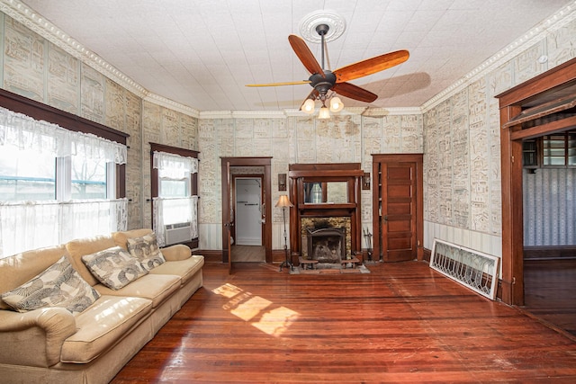 406 7th St, Sealy, TX 77474 - living room featuring a ceiling fan, ornamental molding, and wood-type flooring