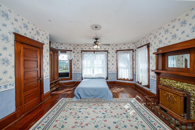 406 7th St, Sealy, TX 77474 - bedroom featuring wallpapered walls, baseboards, and dark wood-style floors
