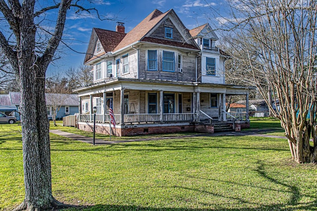 406 7th St, Sealy, TX 77474 - victorian house with a porch, a front yard, a chimney, and crawl space