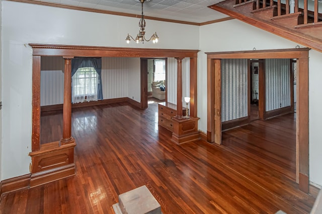 406 7th St, Sealy, TX 77474 - unfurnished living room featuring a chandelier, wood finished floors, ornamental molding, and plenty of natural light