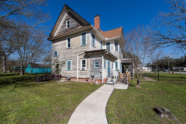 406 7th St, Sealy, TX 77474 - rear view of property with a chimney, crawl space, a yard, and covered porch