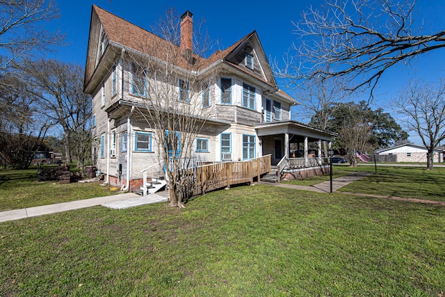 406 7th St, Sealy, TX 77474 - view of front of home featuring a chimney, a front yard, and covered porch