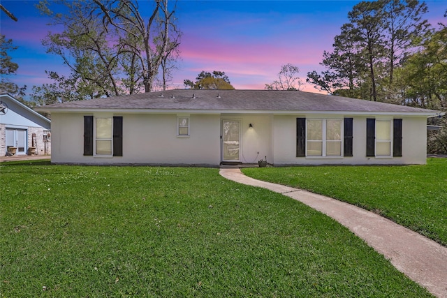 2008 Holbrook St, Dayton, TX 77535 - rear view of house with a lawn, roof with shingles, and stucco siding