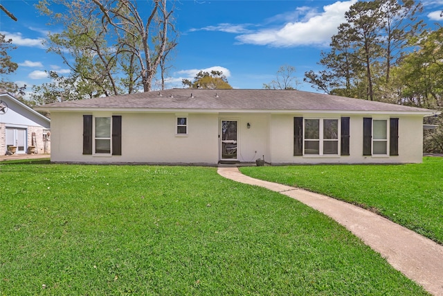 2008 Holbrook St, Dayton, TX 77535 - back of house featuring stucco siding, a yard, and a shingled roof