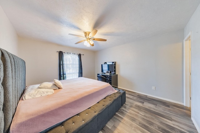 14106 Meyersville Dr, Houston, TX 77049 - bedroom featuring wood finished floors, baseboards, a ceiling fan, and a textured ceiling