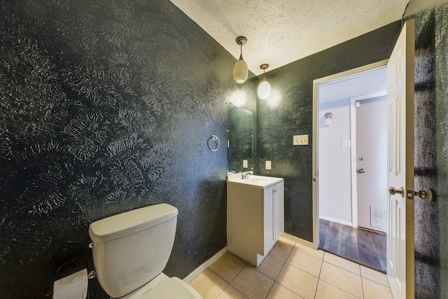 14106 Meyersville Dr, Houston, TX 77049 - bathroom featuring tile patterned floors, vanity, toilet, baseboards, and a textured wall