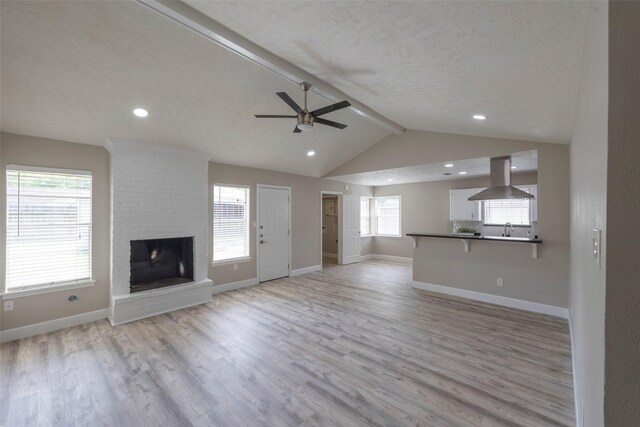 9315 Fairdale Ln, Houston, TX 77063 - unfurnished living room with ceiling fan, light wood-type flooring, a fireplace, baseboards, and recessed lighting