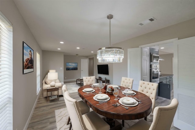 9315 Fairdale Ln, Houston, TX 77063 - dining area with wood finished floors, baseboards, a chandelier, and recessed lighting