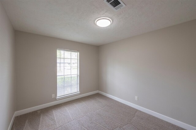 9315 Fairdale Ln, Houston, TX 77063 - spare room featuring baseboards, carpet floors, and a textured ceiling