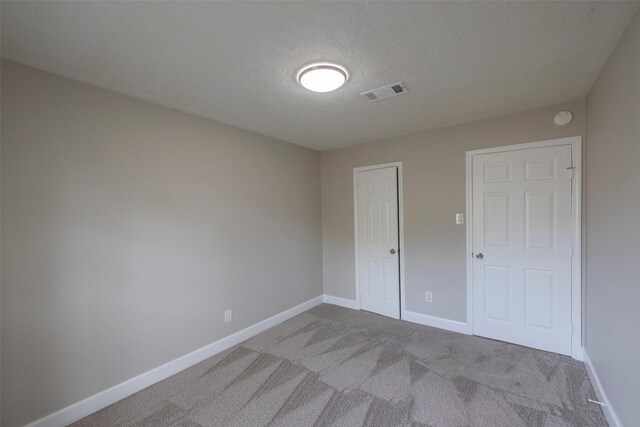 9315 Fairdale Ln, Houston, TX 77063 - unfurnished bedroom featuring carpet, baseboards, and a textured ceiling