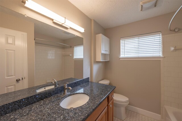 9315 Fairdale Ln, Houston, TX 77063 - full bath featuring tile patterned floors, toilet, vanity, tub / shower combination, and a textured ceiling