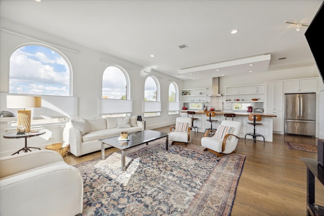 living room featuring visible vents, recessed lighting, and dark wood finished floors