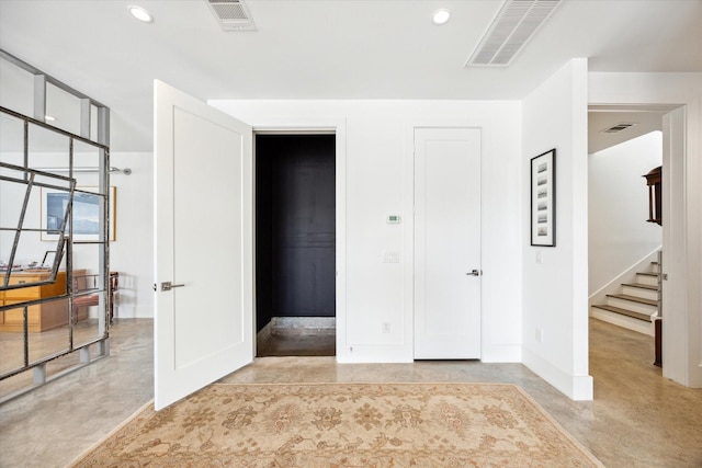 unfurnished bedroom featuring concrete flooring and visible vents