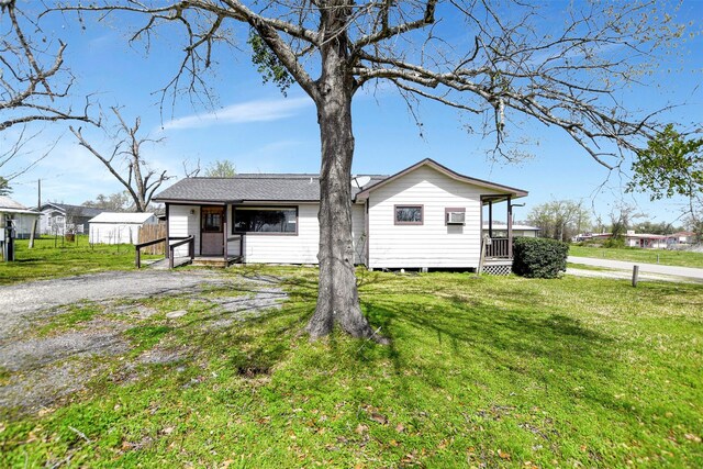 301 Price St, Madisonville, TX 77864 - view of side of property featuring a lawn and entry steps