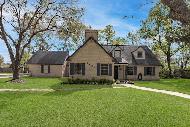 1620 Shady Oaks Dr, Conroe, TX 77301 - cape cod home featuring brick siding, a front lawn, a chimney, and a shingled roof