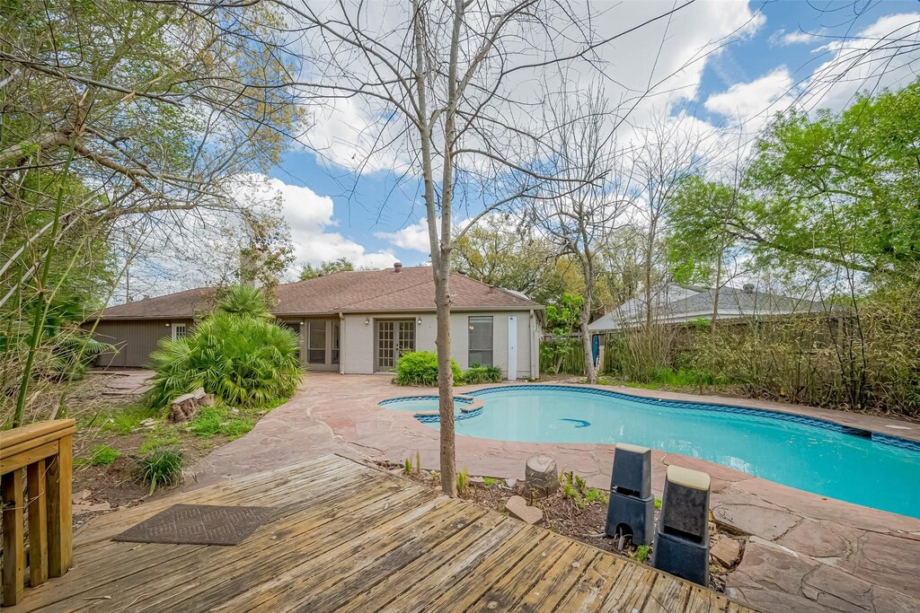 12323 Ella Lee Ln, Houston, TX 77077 - view of pool featuring a deck, a pool with connected hot tub, and french doors