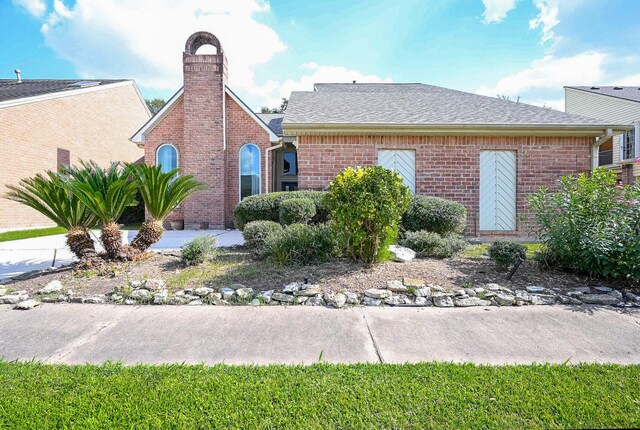 12219 Gladewick Dr, Houston, TX 77077 - view of front of home with brick siding, roof with shingles, and a chimney
