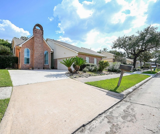 12219 Gladewick Dr, Houston, TX 77077 - view of front of house featuring brick siding, driveway, a chimney, a front yard, and a garage