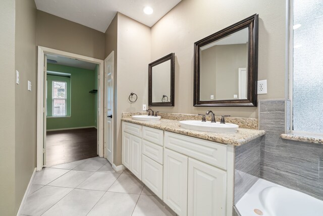 6307 Shoreview Ct, Humble, TX 77346 - bathroom featuring tile patterned flooring, a sink, double vanity, and a bath