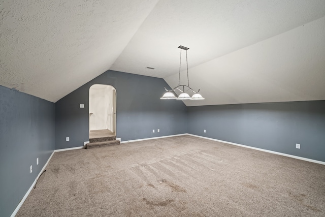 6307 Shoreview Ct, Humble, TX 77346 - bonus room featuring arched walkways, carpet, baseboards, and a textured ceiling