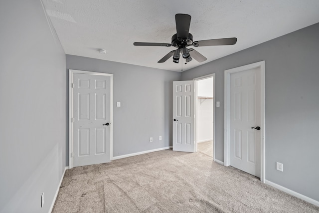 6307 Shoreview Ct, Humble, TX 77346 - unfurnished bedroom with carpet flooring, a ceiling fan, a spacious closet, a textured ceiling, and baseboards