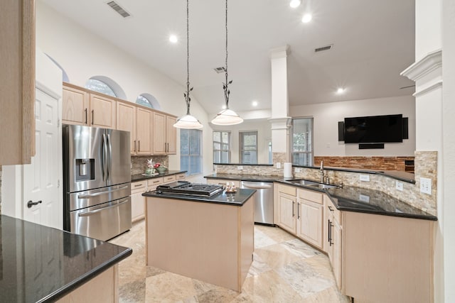 6307 Shoreview Ct, Humble, TX 77346 - kitchen with stainless steel appliances, decorative columns, light brown cabinets, a sink, and a center island