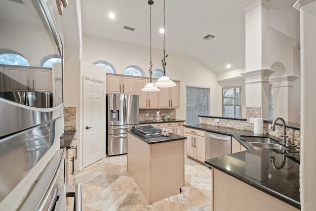 6307 Shoreview Ct, Humble, TX 77346 - kitchen featuring a sink, light brown cabinetry, appliances with stainless steel finishes, a center island, and ornate columns