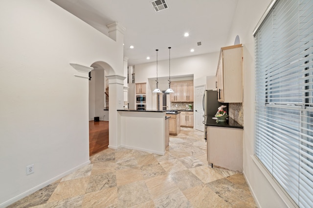 6307 Shoreview Ct, Humble, TX 77346 - kitchen with backsplash, light brown cabinetry, dark countertops, visible vents, and decorative light fixtures