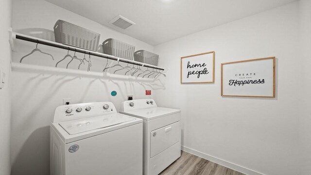 13913 Bahia Bay, Texas City, TX 77591 - washroom with washer and dryer, light wood-style flooring, and baseboards