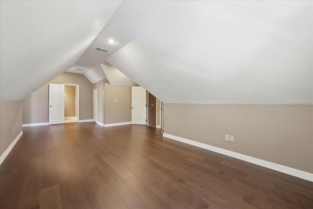 7403 S Park Rd, Lumberton, TX 77657 - additional living space with visible vents, baseboards, lofted ceiling, and dark wood finished floors