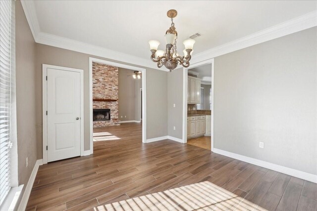 7403 S Park Rd, Lumberton, TX 77657 - unfurnished room featuring visible vents, wood finished floors, a fireplace, crown molding, and baseboards