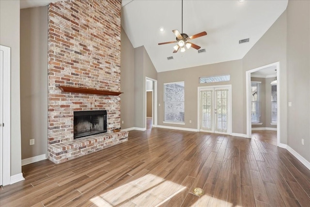 7403 S Park Rd, Lumberton, TX 77657 - unfurnished living room with visible vents, a ceiling fan, wood finished floors, baseboards, and a brick fireplace