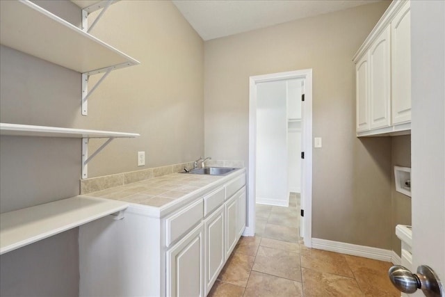 7403 S Park Rd, Lumberton, TX 77657 - laundry room with baseboards, light tile patterned floors, hookup for a washing machine, cabinet space, and a sink