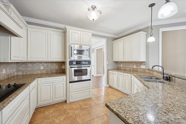 7403 S Park Rd, Lumberton, TX 77657 - kitchen featuring crown molding, pendant lighting, light stone counters, appliances with stainless steel finishes, and a sink