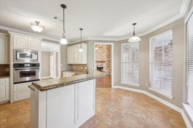 7403 S Park Rd, Lumberton, TX 77657 - kitchen with visible vents, ornamental molding, a sink, appliances with stainless steel finishes, and decorative backsplash