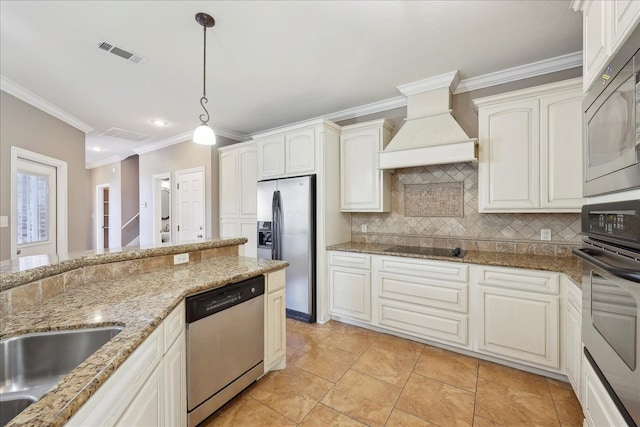 7403 S Park Rd, Lumberton, TX 77657 - kitchen with visible vents, premium range hood, appliances with stainless steel finishes, pendant lighting, and backsplash