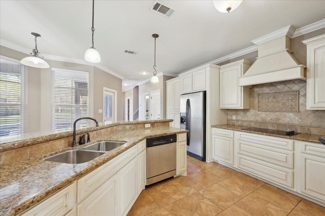 7403 S Park Rd, Lumberton, TX 77657 - kitchen featuring visible vents, custom range hood, decorative backsplash, stainless steel appliances, and a sink