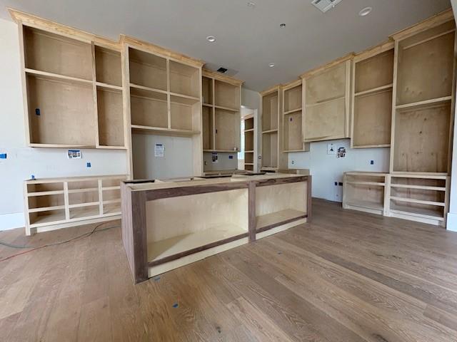 7203 Tickner St, Houston, TX 77055 - kitchen featuring a kitchen island, wood finished floors, and recessed lighting