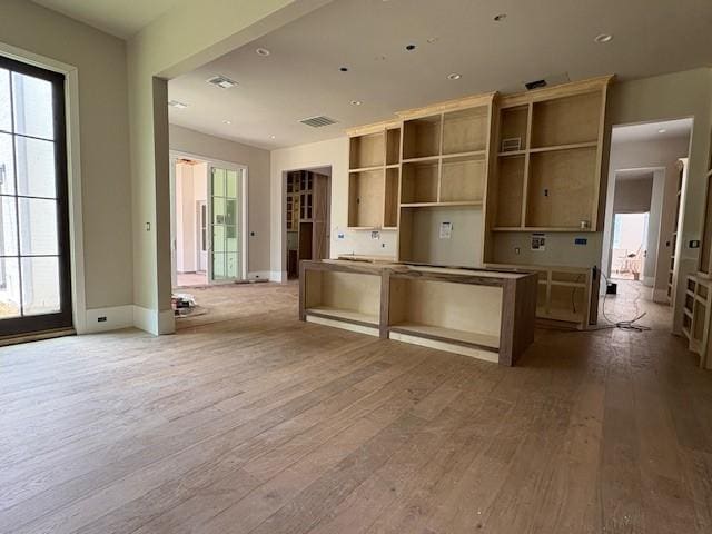 7203 Tickner St, Houston, TX 77055 - kitchen featuring wood-type flooring, baseboards, a kitchen island, and recessed lighting