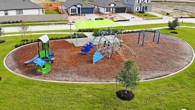 community jungle gym featuring a yard and a residential view