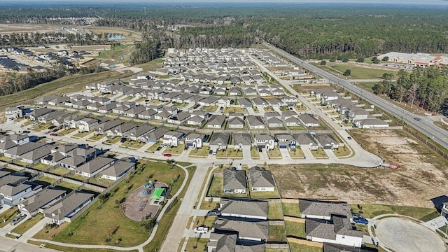 birds eye view of property with a residential view and a view of trees