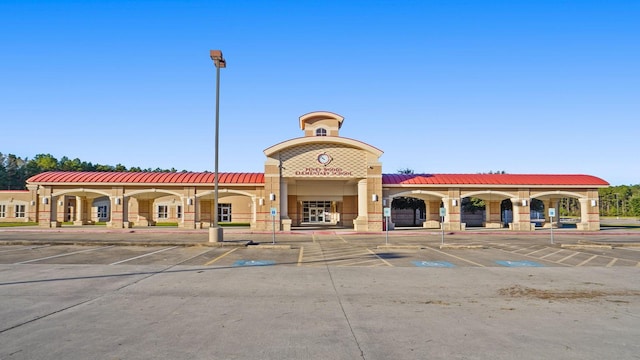 view of property featuring uncovered parking