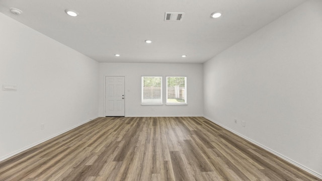 spare room featuring recessed lighting, visible vents, baseboards, and wood finished floors