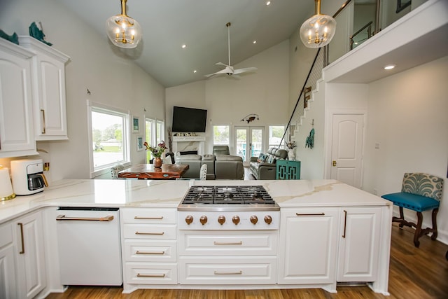 kitchen featuring plenty of natural light, a ceiling fan, light stone countertops, and stainless steel gas cooktop
