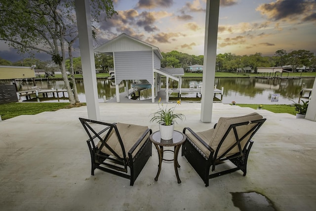 view of patio with a water view, boat lift, and a dock